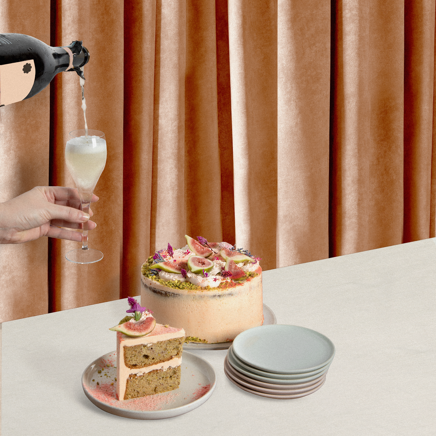 Floss Buttercake sits whole on a table next to a stack of plates and a slice as a glass of champagne is poured